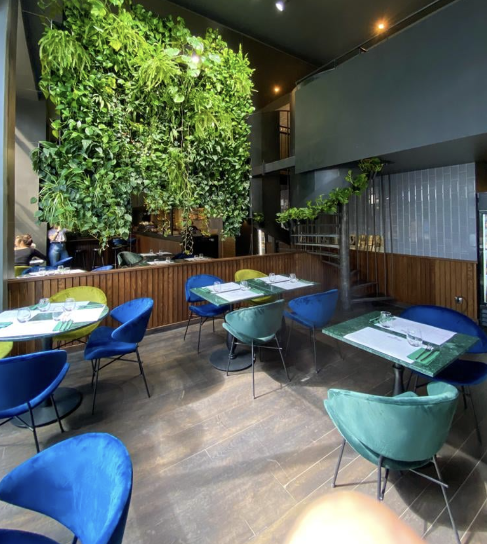 Restaurant interior with green seating and timber wall finish for Zwierzyniec Beer and Fest in Warsaw
